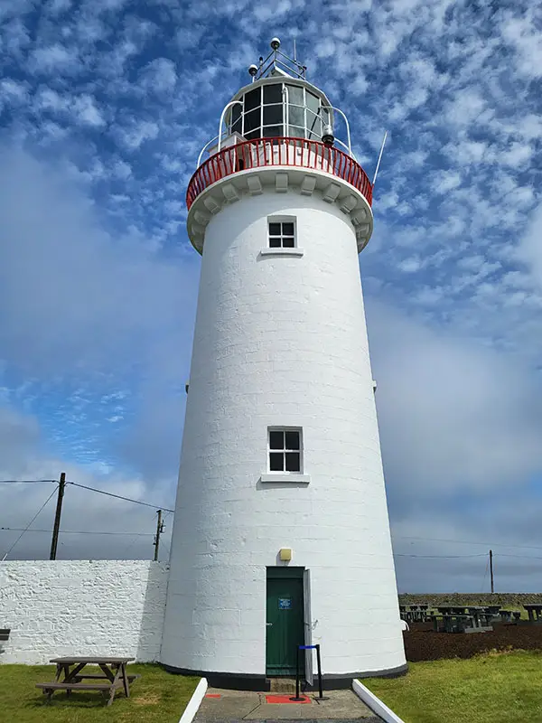white lighthouse with walking area at top